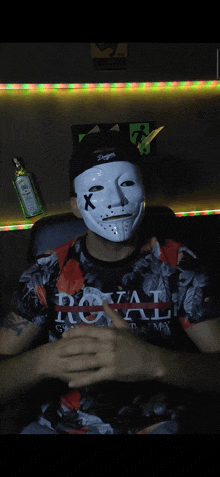 a man wearing a white mask and a shirt that says royal on it