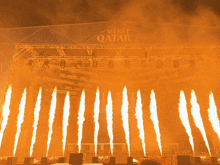 a large stage with a visit qatar sign above it