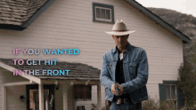 a man in a cowboy hat stands in front of a house with the words " if you wanted to get hit in the front " above him