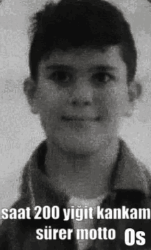 a black and white photo of a young boy with the words `` saat 200 yigit kankam surer motto os '' .