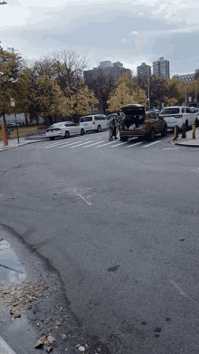 a car with the trunk open is parked on the street