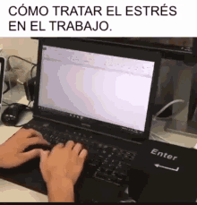 a person is typing on a laptop with a keyboard that says enter