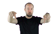 a man in a black shirt is pointing at the camera with both hands