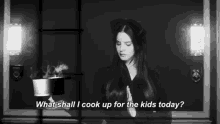 a black and white photo of a woman holding a pot that says `` what shall i cook up for the kids today '' .