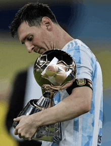 a man holding a trophy that says afl on his arm