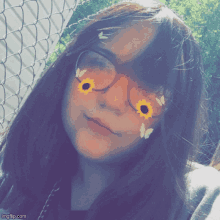 a girl wearing glasses has sunflowers and butterflies in her eyes