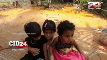 three little girls are sitting in front of a screen that says cid24 on it