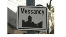 a sign that says messancy with a city skyline