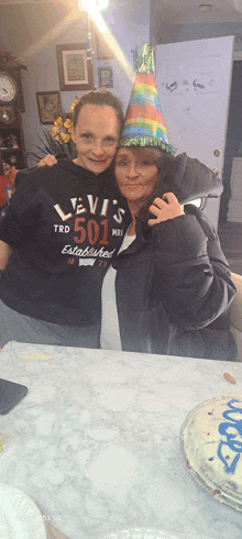 two women posing for a picture with one wearing a levi 's 501 shirt