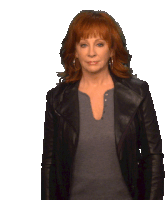 a woman with red hair is wearing a black jacket