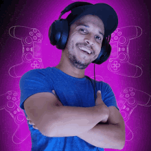 a man wearing headphones stands with his arms crossed in front of a video game controller