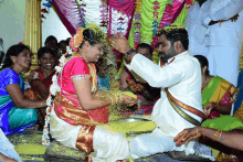 a bride and groom are being showered with yellow powder during their wedding ceremony