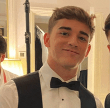 a young man in a tuxedo with a bow tie