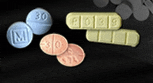 three different types of pills are sitting on a table .