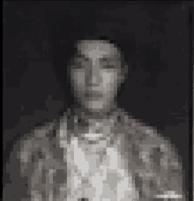 a pixelated image of a man 's face with a black background