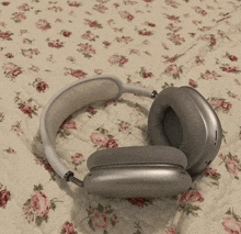 a pair of headphones are laying on a floral quilt