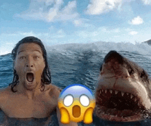 a man is swimming in the ocean next to a shark with a surprised face