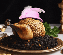 a chicken with a pink hat on top of a pile of raisins