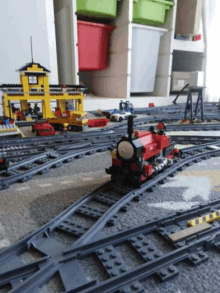 a lego train set with a red train that says ' thomas ' on it