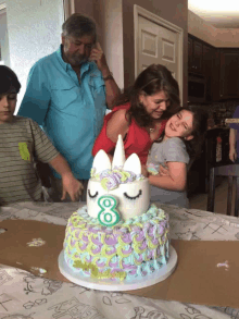 a birthday cake with a unicorn on top has the number 8 on it