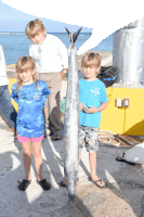 a boy wearing a shirt that says ' fishing ' on it