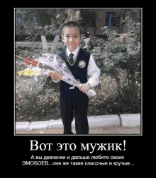 a young boy is holding a bouquet of flowers in front of a sign that says bot