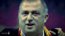 a close up of a man 's face with galatasaray media team written on the bottom