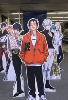 a group of cardboard cutouts of anime characters standing next to each other .