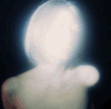 a blurred image of a person 's face with a light coming out of it