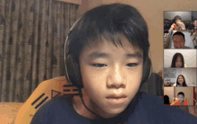 a young boy wearing headphones looks at a screen with a group of people