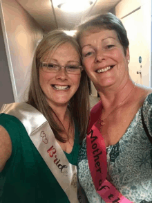 a woman wearing a sash that says bride is standing next to another woman