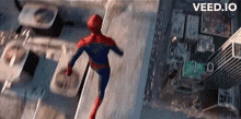 an aerial view of a person in a spiderman costume jumping off a building