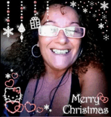 a woman wearing glasses is smiling in front of a merry christmas poster