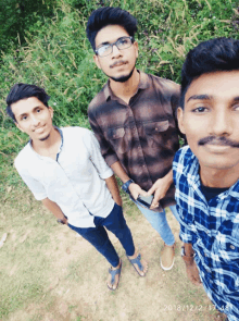 three young men are posing for a picture with the date of december 2nd