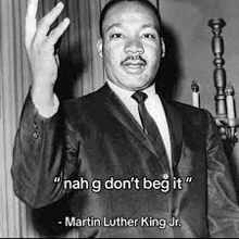 martin luther king jr. is a black and white photo of a man in a suit and tie .