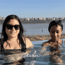 two women are swimming in a pool with the words da fuck on the bottom