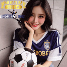 a woman holding a soccer ball in front of a museum bola ad