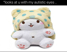 a stuffed animal wearing a yellow and blue polka dot hat with the caption looks at u with my autistic eyes