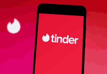 a cell phone with the tinder logo on it