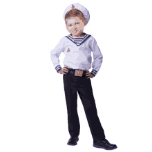 a young boy dressed in a sailor 's uniform with his hands on his hips