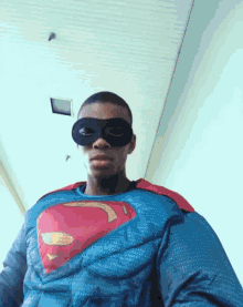 a man dressed in a superman costume and mask