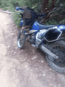 a dirt bike is parked on the side of the road