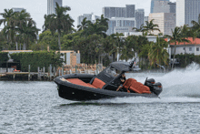 a black and orange boat with a mercury motor on the back