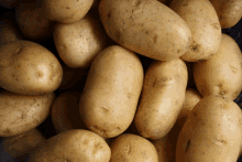 a pile of potatoes with a few spots on them