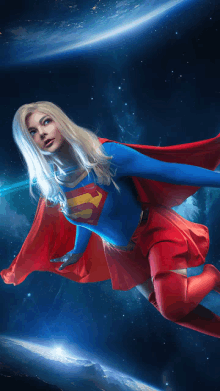 a woman dressed as superman is flying through space