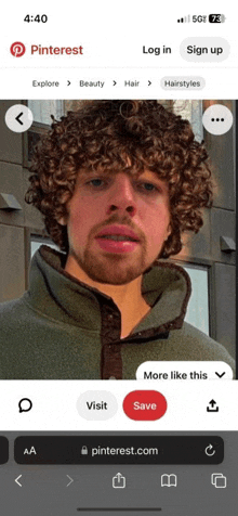 a phone screen shows a man with curly hair and a beard on pinterest