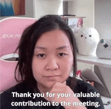 a woman in front of a pink dxr chair says " thank you for your valuable contribution to the meeting "