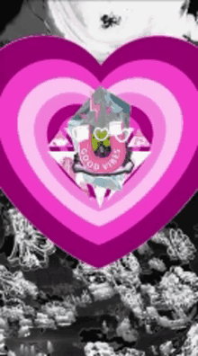 a pink heart with the words good vibes in the center