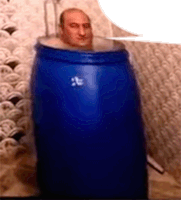 a man is in a blue barrel with a speech bubble above him