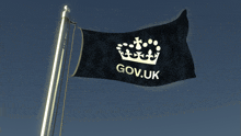 a black flag with a crown and the words gov.uk